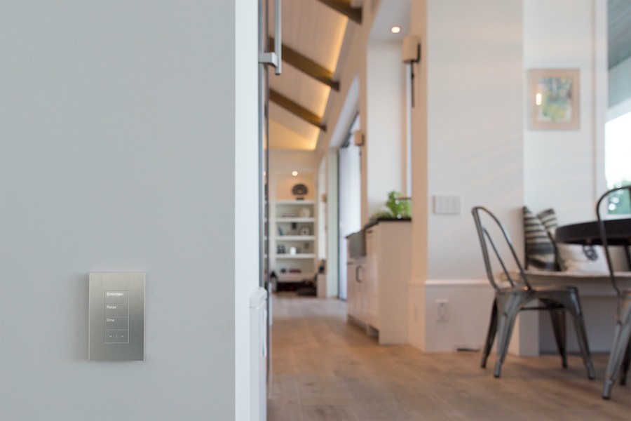 Silver Palladiom lighting control on gray wall in home.