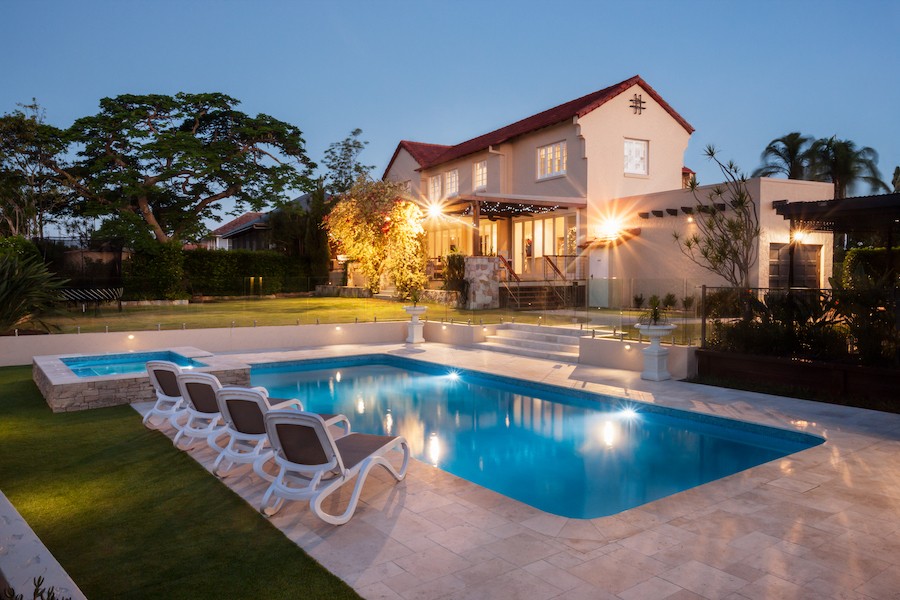 A Boston-area home creates a nighttime oasis with outdoor pool lighting.