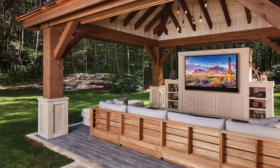 A covered outdoor seating area featuring a Séura TV.
